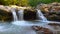 A river flows over rocks in this beautiful scene in the mountains in autumn cinemagraph