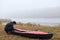 River in fog, kayaker in front of lake with beautiful sky and water, sportsman with canoe at bank of river, extreme activity, guy