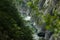 A river in a gorge with a turbulent current, cliffs turned against the water, wildlife and travel