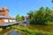 The river Ilmenau in the German medieval town of Lueneburg. The tower of the `Abtsmill` on the left
