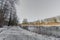 River with its banks with snow on frozen grass and bare trees