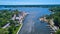 River and lake in country town with dock full of boats