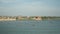 River landscape with fishing boats and riverside town in the background