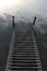 River Landscape of old iron dock looks like a ladder to clouds. Stairway to heaven concept.