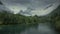 River landscape of Romsdalen with snowy mountains in rain clouds in Norway