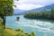 River with a lonely house on a rock on a summer day in mountains