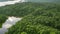 a river meandering through the dense foliage of the Amazon Rainforest The lush greenery and abundant trees create a vibrant and