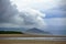 River meeting sea. Nature with green vegetation, mountain and beach