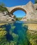 River with old bridge and rocks underwater Spain