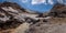 River passing under the thick icy layer of the glacier inside Mutnovsky Volcano crater