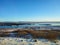 River on the plain in Iceland. The banks are covered with snow. Winter landscape, open spaces