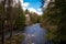 River Rapids by an Old Stone Building