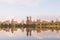 River reflecting modern buildings on a sunny day, Central Park, New York, USA