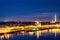 The river reflects the city lights. Twilight city panoramic landscape. View of the Old city over the roofs of houses. Saint