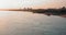 River reflects evening sunlight and barge on sandy bank