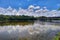 River Road Bridge Leading Coconut trees line Clouds