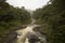 River rushing out of a lush jungle