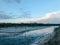 River and sky as well as forest in the background