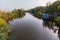 River with a small cafe on a wooden raft. Umbrellas, tables. You can sit, eat and drink