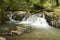 River with some rocks and a small waterfall long exposure