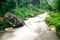 River step waterfall motion with green rain forest and stone background landscape