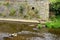 River and stone shore with timber log