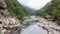 River stream on a green valley in an amazing and peaceful national park with fog and cloudy. Rural scenery mount and canyon in the