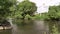 River stream waves. Electricity post and wires. Industrial trash on shore