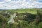 A river and surrounding countryside under a cloudy sky