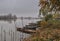 River with tied boats in autumn November grey day