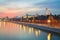 A river tram that sails along the walls of the Moscow Kremlin on a winter evening at sunset