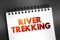 River trekking - mountain stream climbing is a form of hiking or outdoor adventure activity, text on notepad, concept background