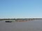 River Tug - Pusher `ASUNCION` and convoy of bardes loaded in navigation along of the Water Way Hidrovia rivers Paraguay Parana