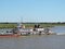 River Tug - Pusher `ASUNCION` and convoy of bardes loaded in navigation along of the Water Way Hidrovia rivers Paraguay Parana