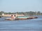 River Tug - Pusher `ASUNCION` and convoy of bardes loaded in navigation along of the Water Way Hidrovia rivers Paraguay Parana