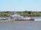 River Tug - Pusher `NUAR B` and convoy of barges loaded in navigation along of the Water Way Hidrovia rivers Paraguay Parana