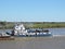 River Tug - Pusher `PATRICIA M` and convoy of barges loaded in navigation along of the Water Way Hidrovia rivers Paraguay Parana