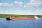 River tugboat moves cargo barge on the Volga river