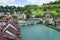 The river with turquoise water and the stone bridge in a sunny day in Bern, Switzerland