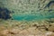 River underwater with rocks and fish reflected