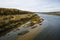 River valley in Russia, clear water with a sandy bottom, forest on the shore.