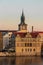 River Vltava and sunlit church tower, Prague city