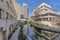 River Walk in San Antonio Texas along tall buildigs with blue sky background