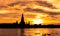 River and Wat Arun Ratchawararam at sunset with beautiful orange sky and clouds. Wat Arun buddhist temple is the landmark