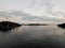 river water with dock and house and clouds