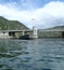 River water and lock with bridge and hills