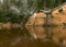 River water reflection landscape, natural composition, Gauja National Park. Rocky sandstone banks of Gauja rivers, river in