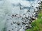 Riverbank with gray wet stones and pebbles. view from above