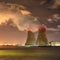 Riverbank with nuclear power plant Doel at night with dramatic clouds, Port of Antwerp