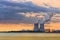 Riverbank with nuclear power plant Doel during a sunset with dramatic cluds, Port of Antwerp